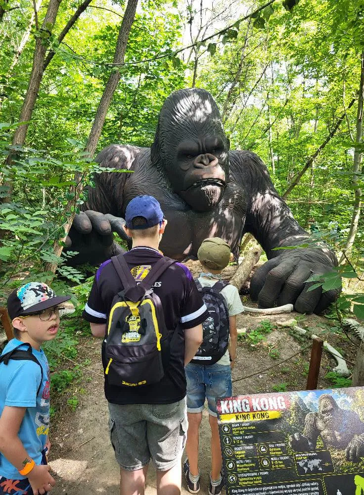 uczniowie podczas wycieczki w parku dinozaurów